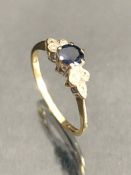 9ct Gold ring Blue Gemstone set in platinum and flanked by six small diamonds size M.5