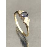 9ct Gold ring Blue Gemstone set in platinum and flanked by six small diamonds size M.5