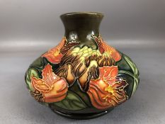 Moorcroft pottery squat vase designed by Philip Gibson, 1997, in the 'Flame of the Forest' pattern,