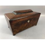 Mahogany tea caddy on bun feet, the interior with two compartments and a glass mixing bowl