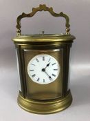French oval brass-cased chiming carriage clock, white enamel dial with Roman numeral hour markers,