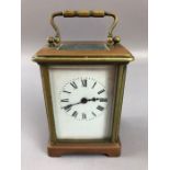 French carriage clock with a brass case, white dial with Roman numerals, marked 'France' to case