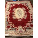 Large red ground, woollen rug with all over floral design, approx 240cm x 335cm