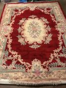 Large red ground, woollen rug with all over floral design, approx 240cm x 335cm