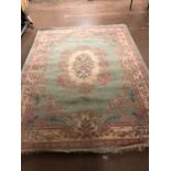Large green ground floral woollen rug, approx 244cm x 333cm