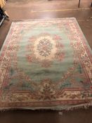 Large green ground floral woollen rug, approx 244cm x 333cm
