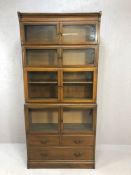 Vintage bookcase with four glass-fronted cupboards and three drawers below, approx 89cm x 26cm x