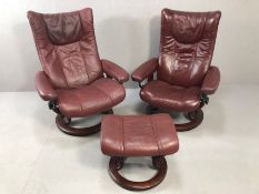 Pair of burgundy leather stressless armchairs with single footstool