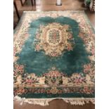 Large green ground, floral design woollen rug, approx 375cm x 275cm