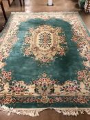 Large green ground, floral design woollen rug, approx 375cm x 275cm
