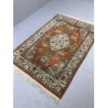 Red ground rug with Indian hunting scenes, approx 200cm x 130cm