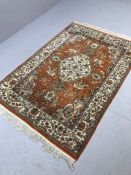Red ground rug with Indian hunting scenes, approx 200cm x 130cm