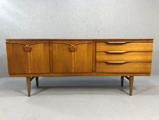 Beautility mid century teak concave sideboard, with arrangement of fall-front drinks cupboard and