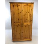 Pine two door wardrobe with internal mirror and hanging rail, approx 103cm x 61cm x 187cm tall