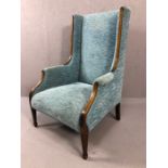 Edwardian fire side armchair with tapering front legs and inlay, upholstered in teal chenille