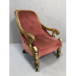 19th Century wooden framed chair with scroll detailing to arms, front castors and pink upholstery
