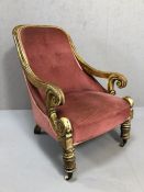 19th Century wooden framed chair with scroll detailing to arms, front castors and pink upholstery