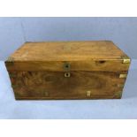 Light wood brass bound campaign chest with brass handles and unmarked brass cartouche to lid (