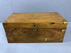 Light wood brass bound campaign chest with brass handles and unmarked brass cartouche to lid (