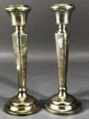 Pair of Silver candlesticks on circular stepped bases approx 18cm tall hallmarked for Birmingham