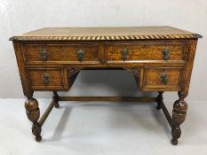 Antique knee hole four drawer desk on baluster legs with carved detailing, approx 106cm x 54cm x