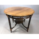 Antique occasional table with fret work design on four legs each comprising four supports and