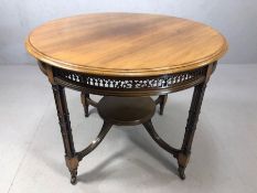 Antique occasional table with fret work design on four legs each comprising four supports and