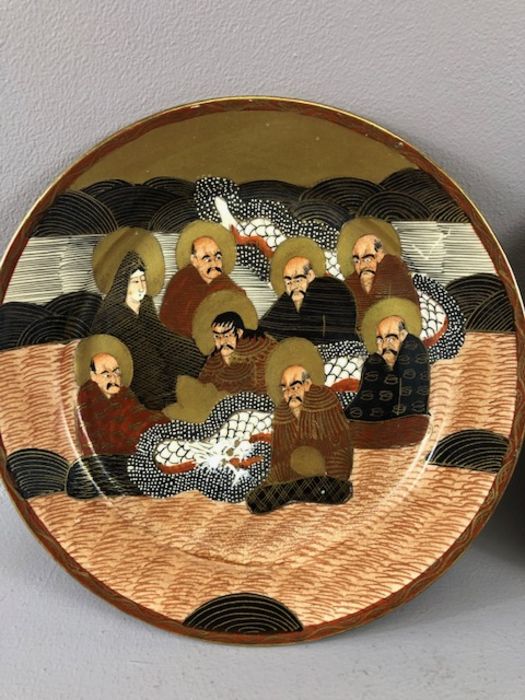 19th Century pair of Japanese hand-painted plates each depicting eight figures, decorated in tones - Image 2 of 17