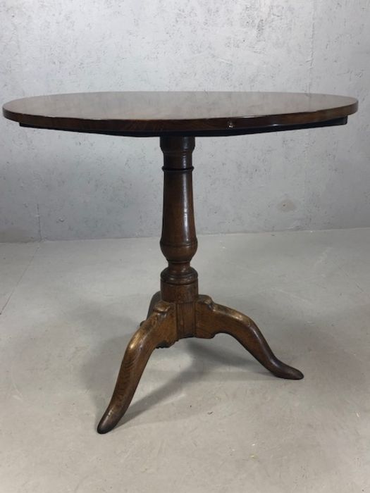 Circular tilt top table on tripod feet with turned central column, approx 74cm in diameter - Image 2 of 6