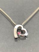 9ct Heart shaped pendant set with diamonds on a silver chain