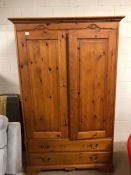 Two door pine wardrobe with two drawers under, hanging rail above, approx 118cm x 60cm x 188cm