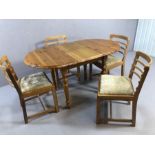 Pine extending dining table accompanied by four Mid Century dining chairs with upholstered seats,