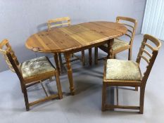 Pine extending dining table accompanied by four Mid Century dining chairs with upholstered seats,
