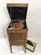 Gramophone by Binns & Co, No 124a, in wooden case on tapering legs, containing a selection of