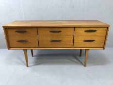 Mid century sideboard by "austinsuite", on tapering legs with six drawers, approx 144cm x 43cm x