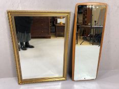 Two wall mirrors, to include one teak framed mid century mirror and one bevel edged gilt framed