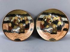 19th Century pair of Japanese hand-painted plates each depicting eight figures, decorated in tones