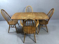 Drop leaf blond Ercol table and four Ercol chairs (one carver)