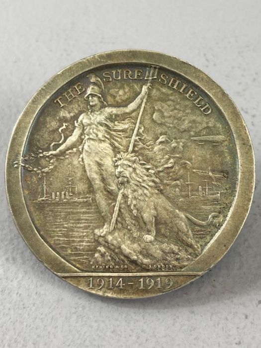 A silver medallion, The Sure Shield 1914-1919 -On 4 August 1919 a pageant was held on the River