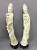 Pair of oriental plaster, intricately carved figurines male, female and child with flowers and