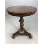 Circular side table with carved central column on tripod ball and claw feet, approx 54cms in