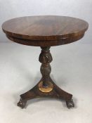 Circular side table with carved central column on tripod ball and claw feet, approx 54cms in