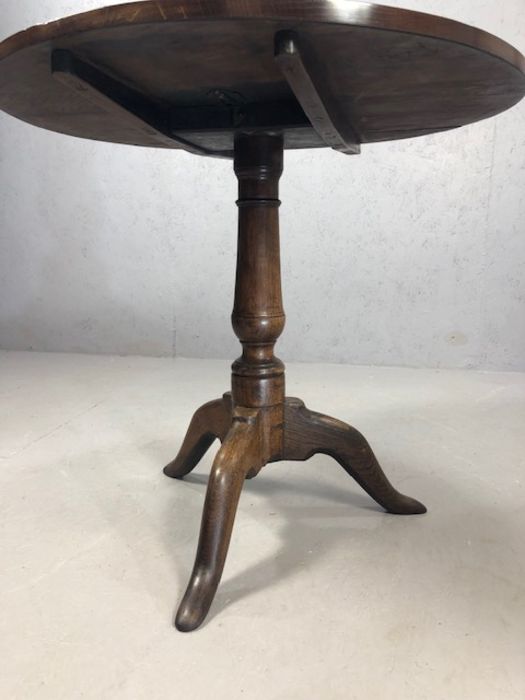 Circular tilt top table on tripod feet with turned central column, approx 74cm in diameter - Image 4 of 6