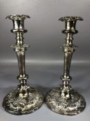A Fine pair of silver coloured candlesticks on circular bases approx 25cm tall
