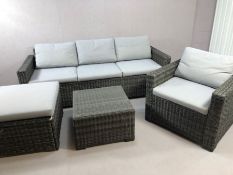 Contemporary rattan garden suite, comprising three seater sofa, armchair, stool and glass topped