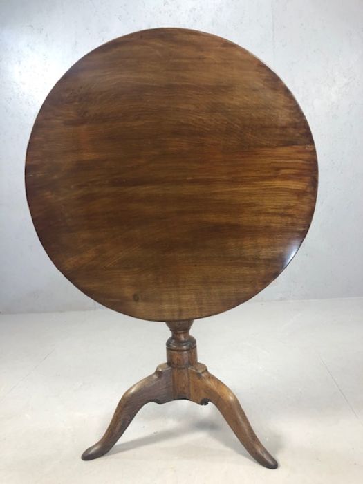 Circular tilt top table on tripod feet with turned central column, approx 74cm in diameter - Image 6 of 6