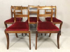 Five dining room chairs with red velvet seat pads