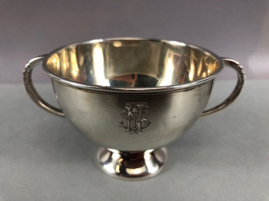 Hallmarked Silver twin handled cup on pedestal base by maker Bendall Brothers approx 9cm in diameter