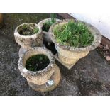 Collection of four concrete garden pots