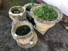 Collection of four concrete garden pots
